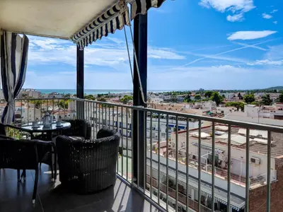 a balcony with a view of a city at Atalaya Apartment by Hello Homes Sitges in Sitges