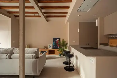 a bedroom with a bed and a brick wall at Casa Badajoz in Barcelona