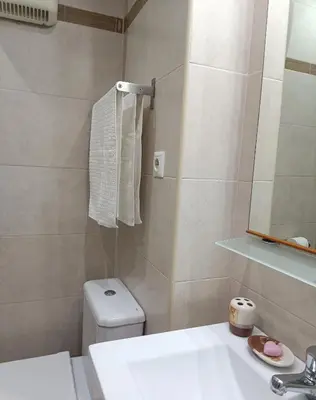 a bathroom with a sink and a toilet and a mirror at Apartamento Gerimar - Gelida/Bcn in Gélida