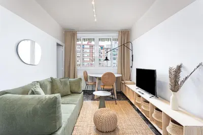 a living room with a couch and a tv at 3 Bdr Apt In Cornella 5 Mins Form The Metro in Cornellà de Llobregat