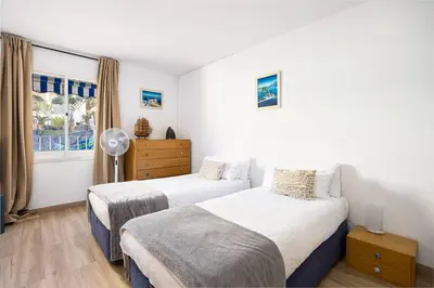 a bedroom with two beds and a window at House 5 Mins From Montgat Beach in Montgat
