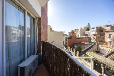 a balcony with a bench and a view of a city at House 5 Mins From Montgat Beach in Montgat