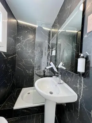 a bathroom with a sink and a mirror at Aldara Sitges in Sitges