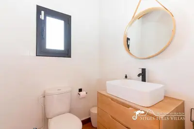 a bathroom with a sink and a mirror at Villa Serranita - Stylish Holiday Home with Views and Air Conditioning 15 mins to Sitges in Olivella