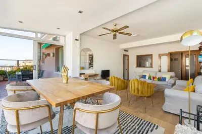 a living room with a table and chairs at Sunny 3BR2BA w Private Terrace AC in Barcelona