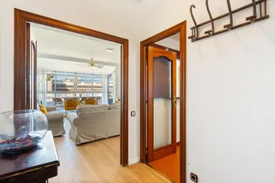 a living room with a door open to a living room at Sunny 3BR2BA w Private Terrace AC in Barcelona