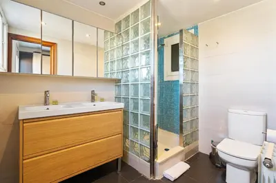 a bathroom with a toilet and a sink and a shower at Sunny 3BR2BA w Private Terrace AC in Barcelona
