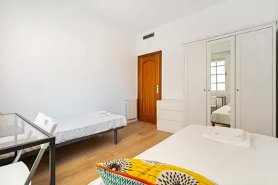 a small room with two beds and a desk at Sunny 3BR2BA w Private Terrace AC in Barcelona