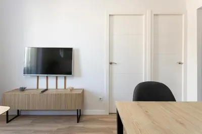 a living room with a flat screen tv on a wall at Lovely Attic With Terrace in Hospitalet de Llobregat