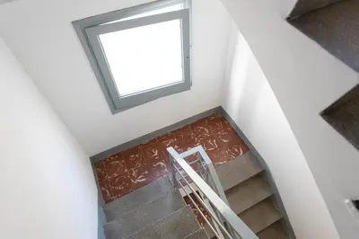 a staircase with a window in a house at Lovely Attic With Terrace in Hospitalet de Llobregat