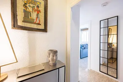 a living room with a vase on a table at 2 Bdr Apt In Cornella 5 Mins Form The Metro in Cornellà de Llobregat