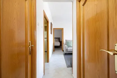 a hallway leading to a room with a bedroom at Cozy Apt In Cornella 2 Mins From The Metro in La Gabarra