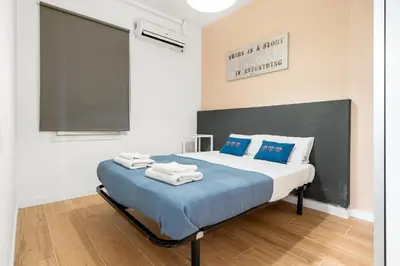 a bedroom with a bed with towels on it at Big Central Barcelona Flat - 4BR for 7 in Barcelona
