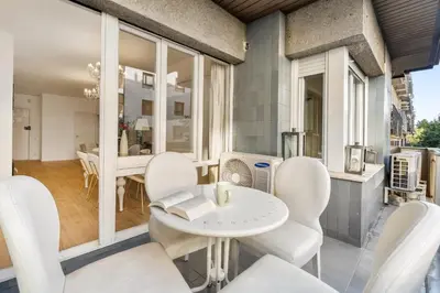 a living room with white chairs and a table at Big Central Barcelona Flat - 4BR for 7 in Barcelona