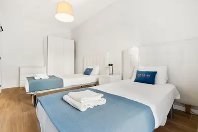 a room with two beds with towels on them at Big Central Barcelona Flat - 4BR for 7 in Barcelona