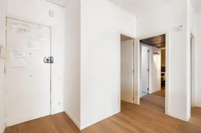 a white kitchen with white cabinets and appliances at Big Central Barcelona Flat - 4BR for 7 in Barcelona