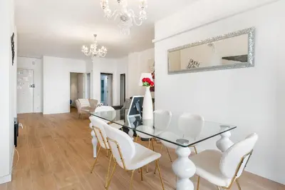 a dining room with a glass table and white chairs at Big Central Barcelona Flat - 4BR for 7 in Barcelona