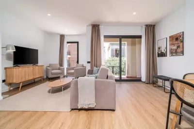 a living room with a couch and a tv at Limehome Barcelona Plaça Pirineus in Hospitalet de Llobregat