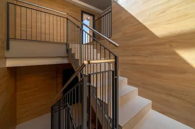 a staircase in a house with wood flooring at Limehome Barcelona Plaça Pirineus in Hospitalet de Llobregat
