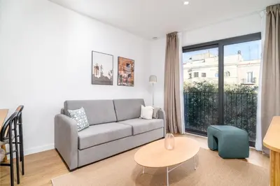 a living room with a couch and a table at Limehome Barcelona Plaça Pirineus in Hospitalet de Llobregat