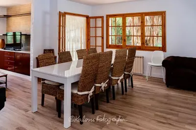a dining room with a white table and chairs at Ca L’Oscana in Bigues i Riells