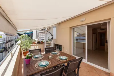 a wooden table and chairs on a balcony at SOUL by Hello Homes Sitges in Sitges