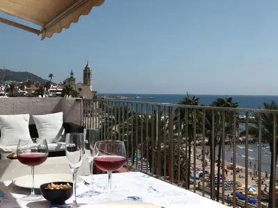 a table with wine glasses on top of a balcony at Sitges Views in Sitges