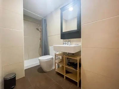 a bathroom with a sink and a toilet and a mirror at Boutique Llobregat in Hospitalet de Llobregat