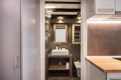 a small bathroom with a sink and a toilet at Beautiful renovated Loft minutes from the beach in Barcelona