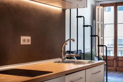 a kitchen with a sink and a counter top at Beautiful renovated Loft minutes from the beach in Barcelona