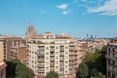 a tall white building in a city with buildings at Sagrada Familia Apartment by Olala Homes in Barcelona