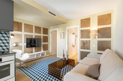 a living room with a couch and a tv at Sagrada Familia Apartment by Olala Homes in Barcelona