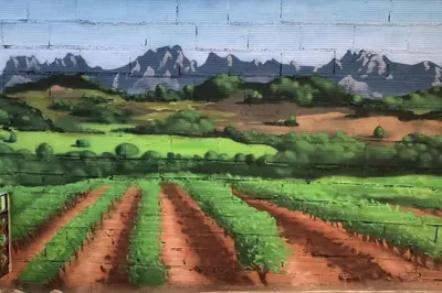 a painting of a farm field with mountains in the background at Ca la Trini - turisme rural in Torrellas de Foix