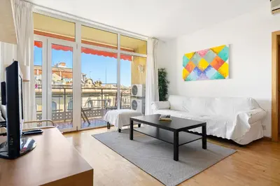 a living room with a white couch and a table at Families & Groups 4BR2BA by Sagrada in Barcelona
