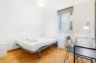 a white bedroom with a bed and a desk at Families & Groups 4BR2BA by Sagrada in Barcelona