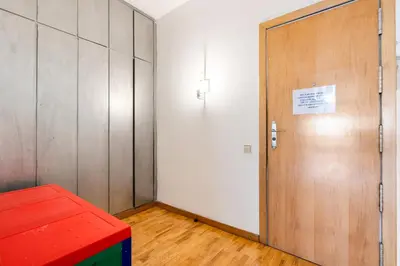 a locker room with a door and a red bench at Families & Groups 4BR2BA by Sagrada in Barcelona