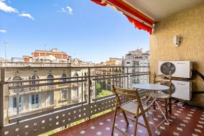 a balcony with a table and chairs and a view of the city at Families & Groups 4BR2BA by Sagrada in Barcelona