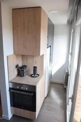 a kitchen with a stove and a refrigerator at Apartament Sant Jordi in Sant Joan de Vilatorrada