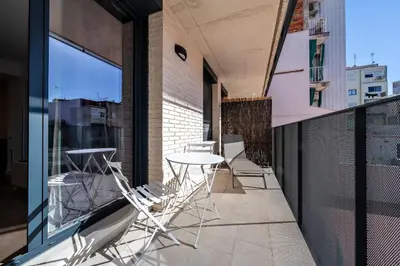 a patio with a table and chairs on a balcony at Habitat Apartments Teatre in Hospitalet de Llobregat
