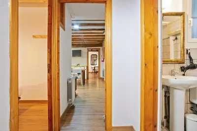 a hallway leading to a kitchen with a sink at Las Ramblas, comfort in BCN for 8 persons in Barcelona