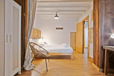 a bedroom with a bed and a chair in it at Las Ramblas, comfort in BCN for 8 persons in Barcelona