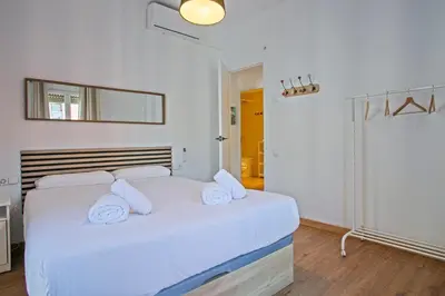 a bedroom with a large white bed with white pillows at Heaven With a Garden at Las Ramblas in Barcelona