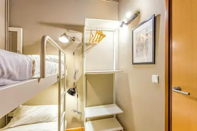 a hallway leading to a bedroom with bunk beds at The Collection Barcelona - Paseo de Gracia sunny 2BR penthouse in Barcelona