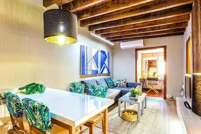 a bedroom with a large bed and a bathroom at The Collection Barcelona - Paseo de Gracia sunny 2BR penthouse in Barcelona