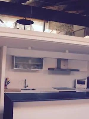 a kitchen with a sink and a microwave at CasaOller in Manresa