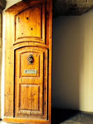 a wooden door with a handle on top of it at CasaOller in Manresa
