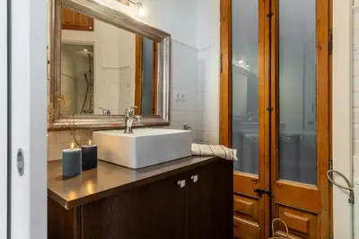 a bathroom with a sink and a mirror at Canela Homes BARCELONA FAMILY in Barcelona