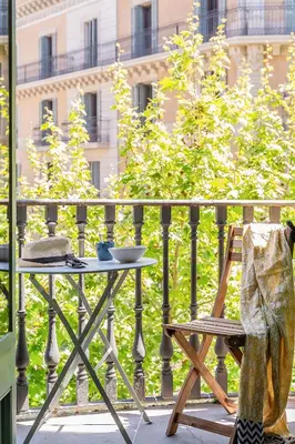 a table and a chair on a balcony at Canela Homes BARCELONA FAMILY in Barcelona
