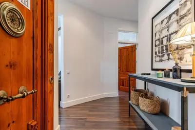 a living room with a table and a hallway at Canela Homes BARCELONA FAMILY in Barcelona
