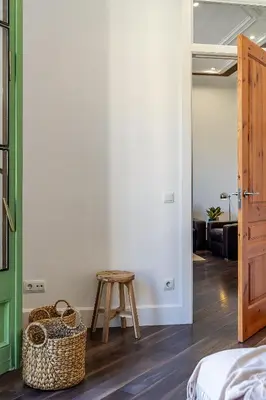 a bedroom with a bed and a stool and a table at Canela Homes BARCELONA FAMILY in Barcelona